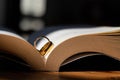 Two wedding rings are placed on the open Bible placed on the table as wedding rings prepared for lovers to wear and read Bible Royalty Free Stock Photo