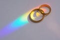 Two wedding rings with rainbow