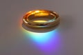 Two wedding rings with rainbow light