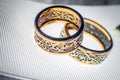 Two wedding rings with rare design on white broad ribbon