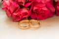 Two wedding rings, red roses Royalty Free Stock Photo
