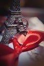 Two wedding rings with red tape, bridal veil and miniature Eiffel Tower Royalty Free Stock Photo