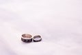 Two wedding rings silver on white background with copy space. rings with runes . concept of love and marriage Royalty Free Stock Photo