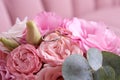 Two wedding rings of white and yellow gold on a bouquet of pink roses. Royalty Free Stock Photo