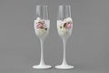 Two wedding wine glasses decorated with lace and roses on gray background Royalty Free Stock Photo