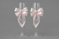 Two wedding wine glasses decorated with pink ribbons