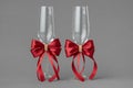 Two wedding wine glasses decorates with red bows. Royalty Free Stock Photo