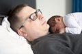 Two week newborn baby with father in bed