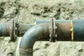 Two welded pipes with bolts and insulation close up.