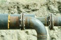 Two welded pipes with bolts and insulation closeup.