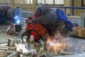 Two Welders With Torch And Welding Sparks Of Molten Metal Royalty Free Stock Photo