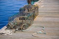 Two well used lobster pots sitting on a dock