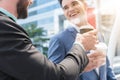 Two Westerner Business men talk with paper cup of hot coffee in Royalty Free Stock Photo