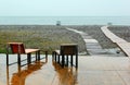 Two wet chairs on empty beach at rainy day in Batumi, Georgia Royalty Free Stock Photo