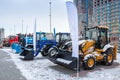 Two wheeled tractors, a bulldozer and snow removal machinery at an industrial exhibition in winter Royalty Free Stock Photo