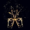 Two whiskey glasses clinking together with splashes. whisky splash. Royalty Free Stock Photo