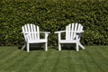 Two white adirondack chairs