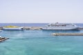 Two white auto ferries lying at a pier.