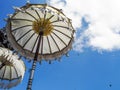 Two white Balinese umbrellas against a blue sky background Royalty Free Stock Photo