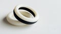 Two white and black bracelets are laying on a white surface Royalty Free Stock Photo