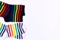 Two white and black pair of socks with colorful striped pattern for feet. Fashionable clean cotton clothes with funny print. Top Royalty Free Stock Photo