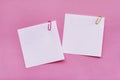 Two white blank note papers with clips on bright pink background Royalty Free Stock Photo