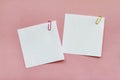 Two white blank note papers with clips on light pink background Royalty Free Stock Photo