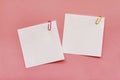 Two white blank note papers with clips on pink background Royalty Free Stock Photo