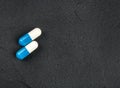 Two blue and white capsules Royalty Free Stock Photo