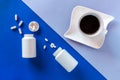 Two white bottle, pills, coffee cup on blue background. Concept Insomnia, full moon time, sleep problems, soporific. Mockup, Top Royalty Free Stock Photo