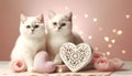 two white British cats sitting near a large retro-style decorative heart on a background bokeh