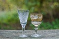A two of white and brown glass crystal goblets on a gray wooden table Royalty Free Stock Photo