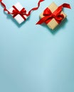 Two white brown paper gift boxes with a red satin ribbon bow and happy birthday sign on top on blue background. Christmas holiday Royalty Free Stock Photo