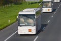 Two white buses on the highway at sunny day Royalty Free Stock Photo