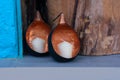 Two white candles on the shelf in spheric bronze shells. Royalty Free Stock Photo