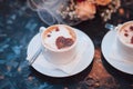 Two white cappuccino cups with hearts and wedding rings, bride bouquet on the table Royalty Free Stock Photo