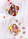 Two white ceramic bowls with colorful candies and jelly beans. Royalty Free Stock Photo