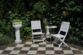 Two chairs and table on the terrace in the house yard Royalty Free Stock Photo