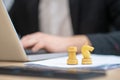 Two white chess pieces standing near laptop
