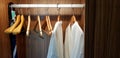 Two white clean bathrobes cloth or robe with wooden hanger and hanging inside dark brown closets Royalty Free Stock Photo