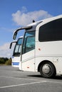 Two White Coach Buses and Summer Sky