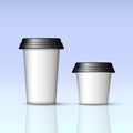 Two white coffee cups with black lids