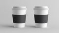 Two White Coffee Cups with Black Sleeves on White Background Royalty Free Stock Photo
