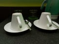 Two white coffee cups and tea spoons put upside down with water glasses and kettle in the background Royalty Free Stock Photo