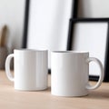 Two white coffee mugs sitting on top of a wooden table Royalty Free Stock Photo