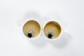 Two white cups of coffee with froth. On white background. Breakfast.