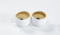 Two white cups of coffee with froth. On white background. Breakfast.