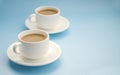 Two white cups coffee with milk, light blue background, side view. Americano. Copy space Royalty Free Stock Photo
