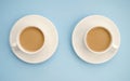 Two white cups coffee with milk, light blue background, top view. Americano. Copy space Royalty Free Stock Photo