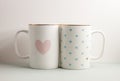 Two white cups with lovely heart prints